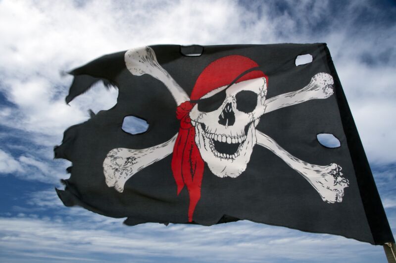 A pirate flag with a skull and crossbones blowing in the wind