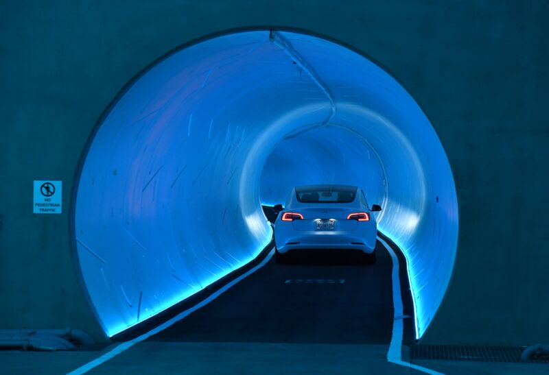 A Tesla car drives through a tunnel in the Central Station during a media preview of the Las Vegas Convention Center Loop on April 9, 2021 in Las Vegas, Nevada.